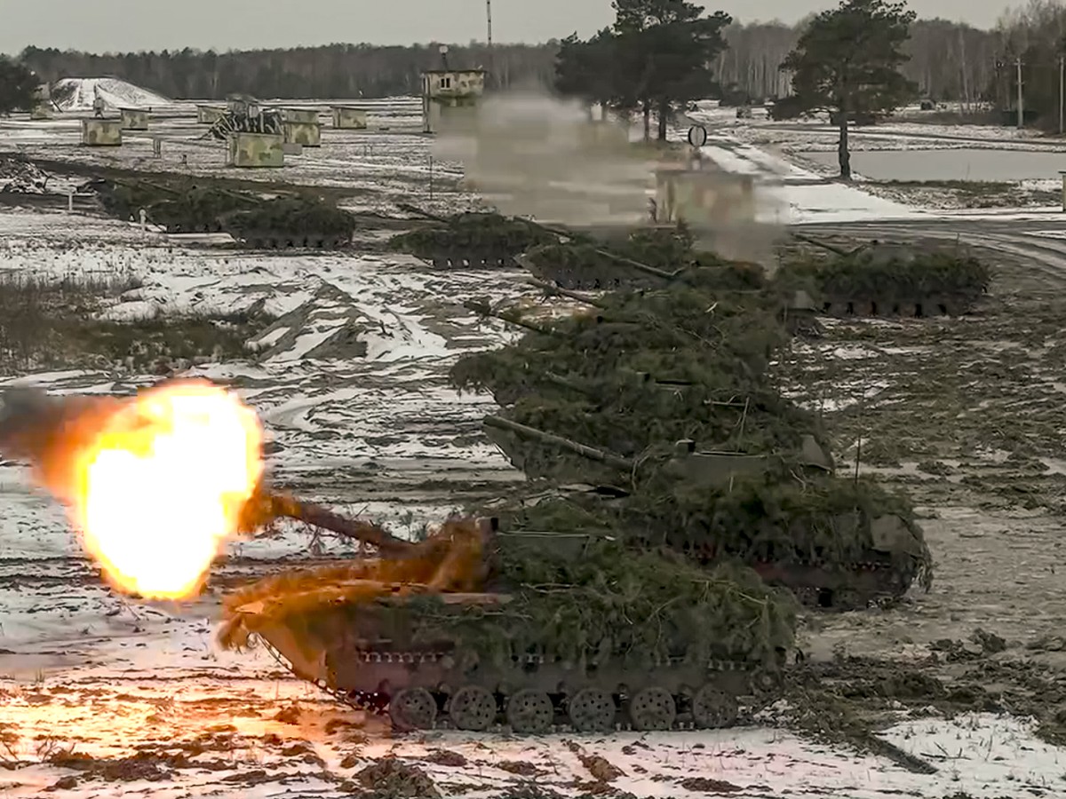 FILE - In this photo taken from video and released by the Russian Defense Ministry Press Service on Friday, Feb. 4, 2022, armored vehicles fire during the Belarusian and Russian joint military drills  ...