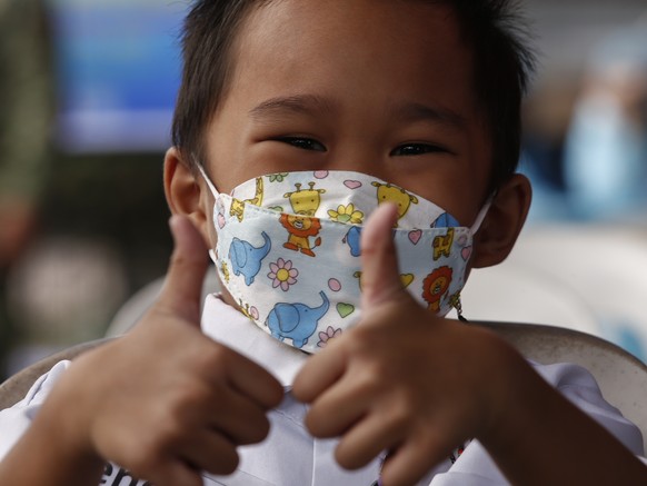 epa09624994 A student reacts after undergoing a COVID-19 antigen test and before attending an in-person class at an elementary school in Quezon City, Metro Manila, Philippines, 06 December 2021. Some  ...