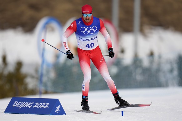 Dario Cologna, of Switzerland, competes during the men&#039;s 15km classic cross-country skiing competition at the 2022 Winter Olympics, Friday, Feb. 11, 2022, in Zhangjiakou, China. (AP Photo/Alessan ...