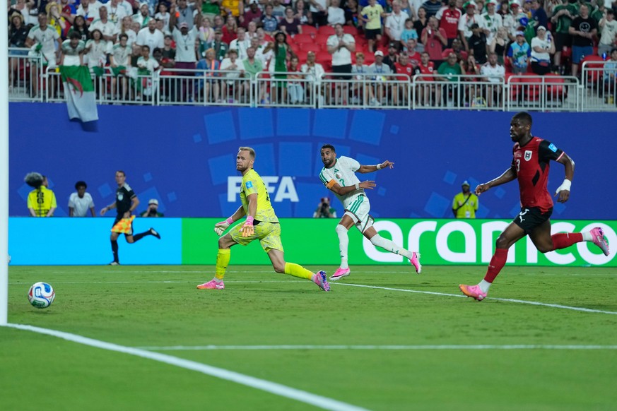 Algeria's Riyad Mahrez (7) scores the team's third goal past Austria goalkeeper Alexander Schlager (1) during the World Cup Group J soccer match between Algeria and Austria in Kansas City, M ...