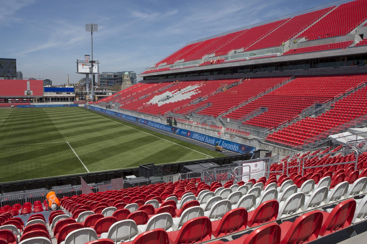 A worker fixes a seat at Toronto FC's BMO Field on Thursday, May 7, 2015, as work continues to ready the newly revamped stadium ahead of the Sunday home opener. (Chris Young/The Canadian Press vi ...