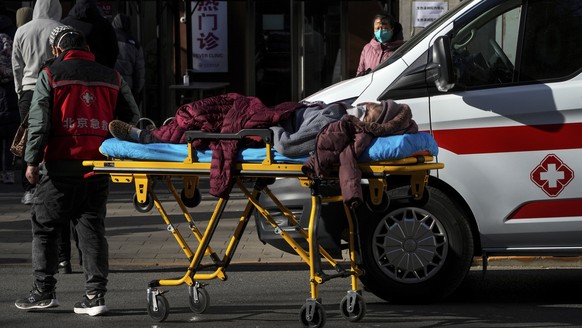 An elderly woman on a stretcher is wheeled into the fever clinic at a hospital in Beijing, Sunday, Dec. 11, 2022. Facing a surge in COVID-19 cases, China is setting up more intensive care facilities a ...