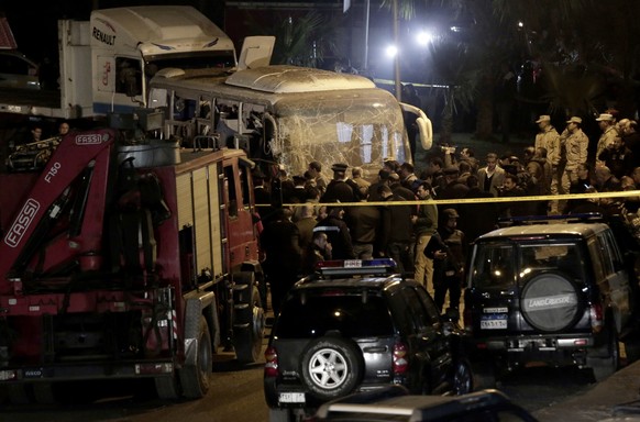 Security forces stand near a tourist bus after a roadside bomb in an area near the Giza Pyramids in Cairo, Egypt. Egypt&#039;s Interior Ministry said in a statement that two Vietnamese tourists were k ...