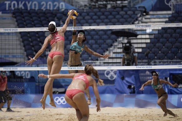 Tanja Huberli, left, of Switzerland, hits a shot as Miki Ishi, of Japan, defends while teammates Nina Betschart, of Switzerland, bottom, and Megumi Murakami, of Japan, close in during a women&#039;s b ...