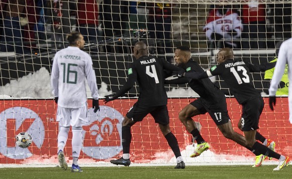 Canada&#039;s Cyle Larin (17), Kamal Miller (4) and Atiba Hutchinson (13) celebrate a goal against Mexico during the second half of a World Cup soccer qualifying match in Edmonton, Alberta, Tuesday, N ...