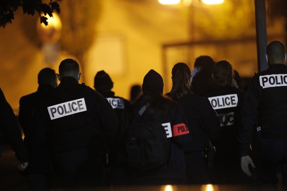 French police officers gather outside a high school after a history teacher who opened a discussion with students on caricatures of Islam&#039;s Prophet Muhammad was beheaded, Friday, Oct. 16, 2020 in ...