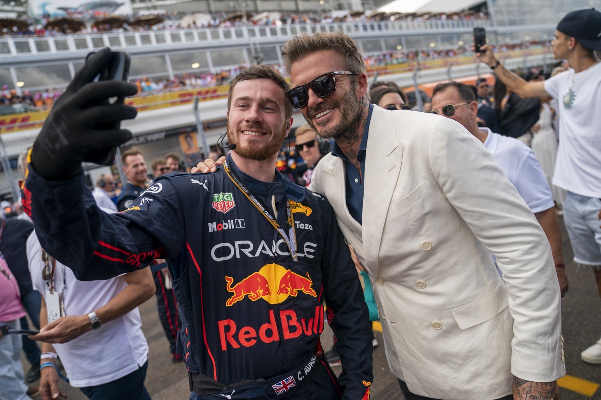 epa09934837 Former English professional footballer and the current president and co-owner of Inter Miami CF David Beckham poses for a picture with a Red Bull team member on the grid prior to the Formu ...
