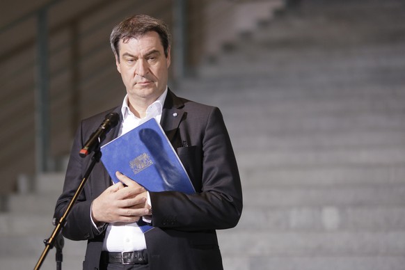 Christian Social Union, CSU, chairman and Bavarian governor Markus Soeder briefs the media at the chancellery in Berlin, Germany, early Thursday, April 23, 2020. Germany's ruling coalition parties dis ...