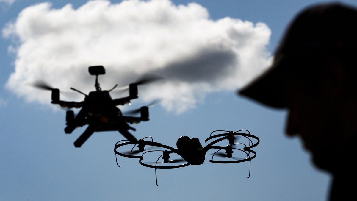 A man monitors flight data on a computer as senseFly and Intel drones fly during a media preview of "U-Space", a newly developed set of services and procedures aiming for the registration an ...