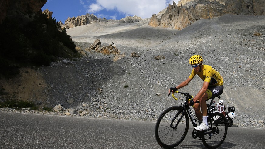 Britain's Chris Froome, wearing the overall leader's yellow jersey, climbs Izoard pass during the eighteenth stage of the Tour de France cycling race over 179.5 kilometers (111.5 miles) with start in  ...
