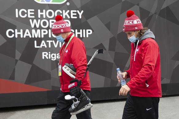 Tommy Albelin, left, assistant coach of Switzerland national ice hockey team, and Patrick Fischer, 2nd left, head coach of Switzerland national ice hockey team, arrive at the Olympic Sport Center afte ...