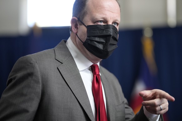 Colorado Gov. Jared Polis wears a face covering as he speaks during a news conference on the state&#039;s response to the COVID-19 pandemic, Tuesday, Dec. 7, 2021, in Denver. (AP Photo/David Zalubowsk ...