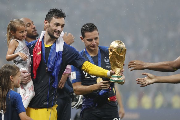 France goalkeeper Hugo Lloris gives the trophy to teammates after the final match between France and Croatia at the 2018 soccer World Cup in the Luzhniki Stadium in Moscow, Russia, Sunday, July 15, 20 ...