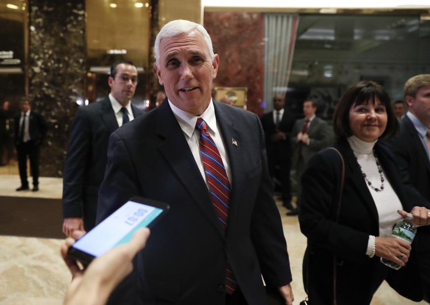 Vice President-elect Mike Pence walks past media as he leaves Trump Tower with his wife Karen, Tuesday, Nov. 15, 2016, in New York. (AP Photo/Carolyn Kaster)