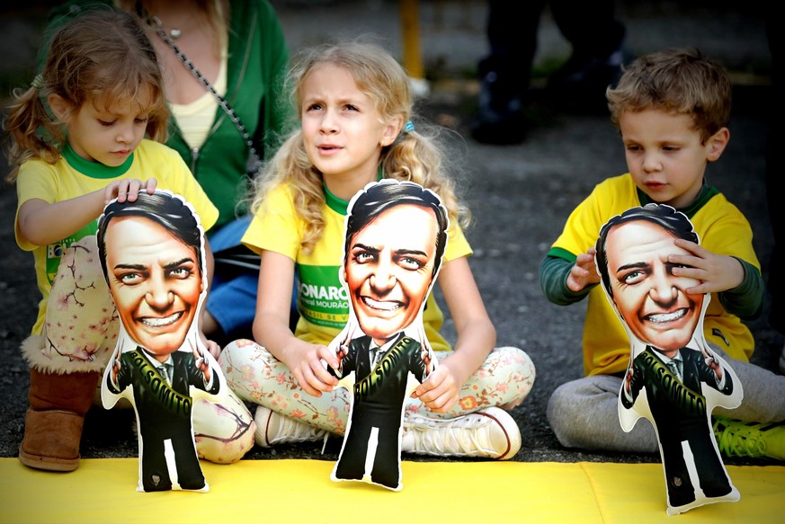 Kinder spielten mit Pappfiguren von Jair Bolsonaro bei einem seiner Auftritte im September.&nbsp;