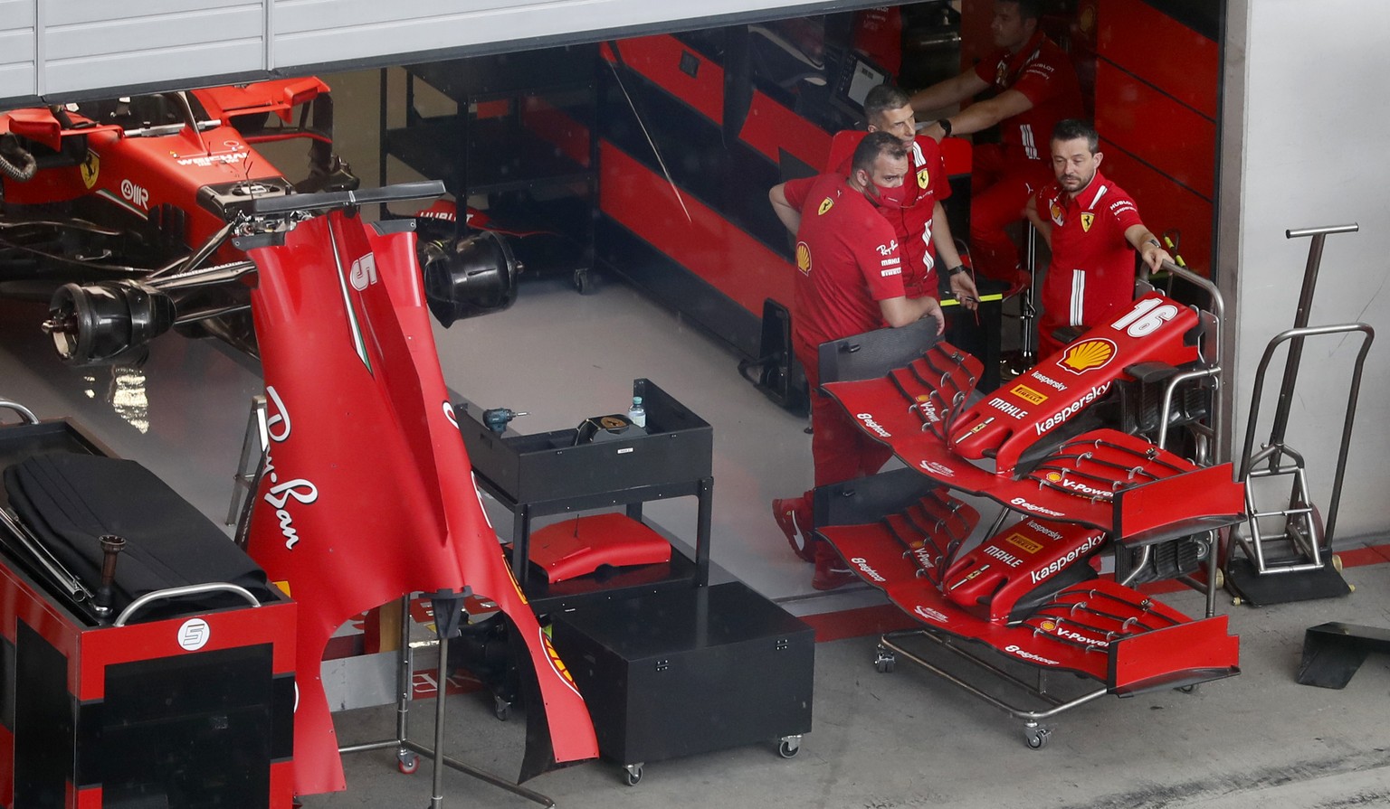 Ferrari technicians pause as they work on Sebastian Vettel&#039;s car the at the Red Bull Ring racetrack in Spielberg in Spielberg, Austria, Thursday, July 2, 2020. Austrian Formula One Grand Prix wil ...