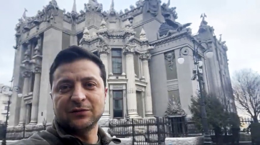 In this photo provided by the Ukrainian Presidential Press Office, Ukrainian President Volodymyr Zelenskyy speaks to the nation via his phone in the center of Kyiv, Ukraine, Saturday, Feb. 26, 2022. R ...