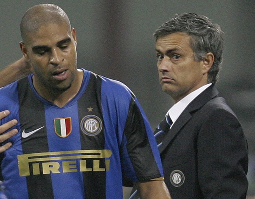 FILE - In this Oct. 22, 2008 file photo Inter Milan forward Adriano of Brazil, left, walks past Inter Portuguese coach Jose Mourinho, right, during a group B Champions League soccer match between Inte ...