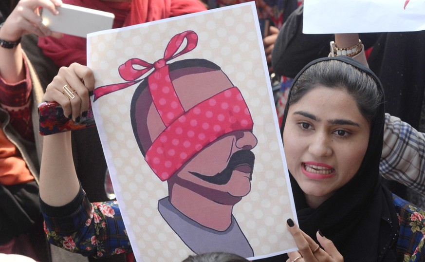 epa07403435 People hold depection of captured Indian Air Force Pilot Wing Commander Abhinandan, as they shout anti-India slogans during a protest in Lahore, Pakistan, 28 February 2019. Pakistan&#039;s ...