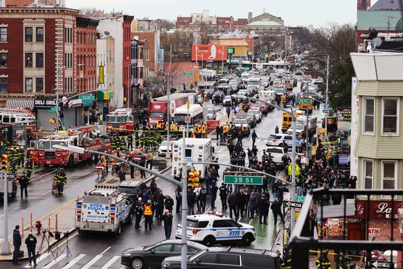 epa09886098 New York City Police, New York City Fire Department, and Federal officials on the scene of a reported multiple shooting at a New York City Subway station in the Brooklyn borough of New Yor ...