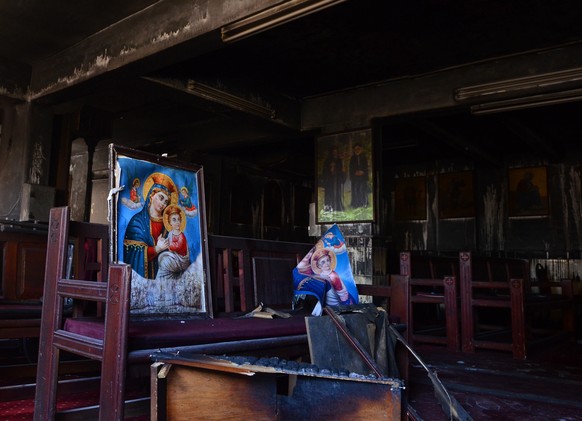 Burned furniture and religious imagery are seen at the site of a fire inside the Abu Sefein Coptic church that killed at least 40 people and injured some 14 others, in the densely populated neighborho ...