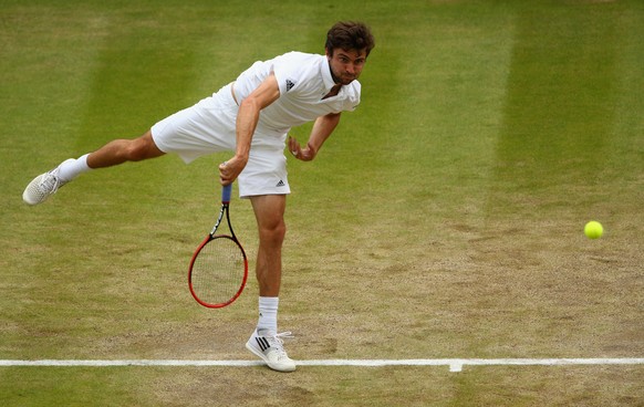 LONDON, ENGLAND - JULY 08: Gilles Simon of France serves in his Gentlemens Singles Quarter Final match against Roger Federer of Switzerland during day nine of the Wimbledon Lawn Tennis Championships a ...