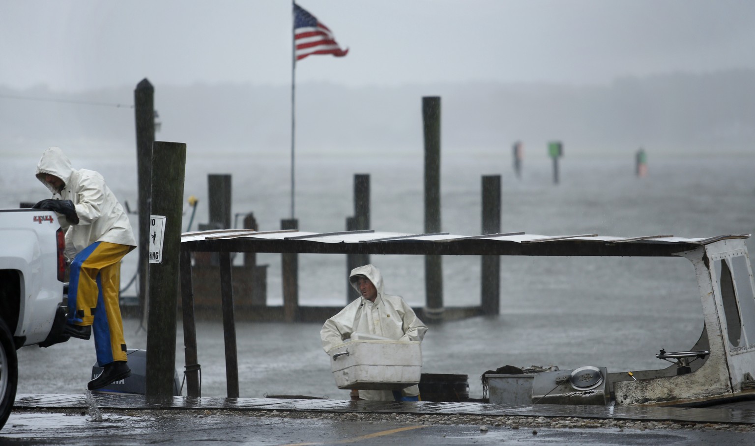 Charlie Gregory, center, a local crabber, and his son Zach check their boat as Tropical Storm Hermine approaches Virginia Beach, Va., Saturday, Sept. 3, 2016. The National Hurricane Center says Tropic ...
