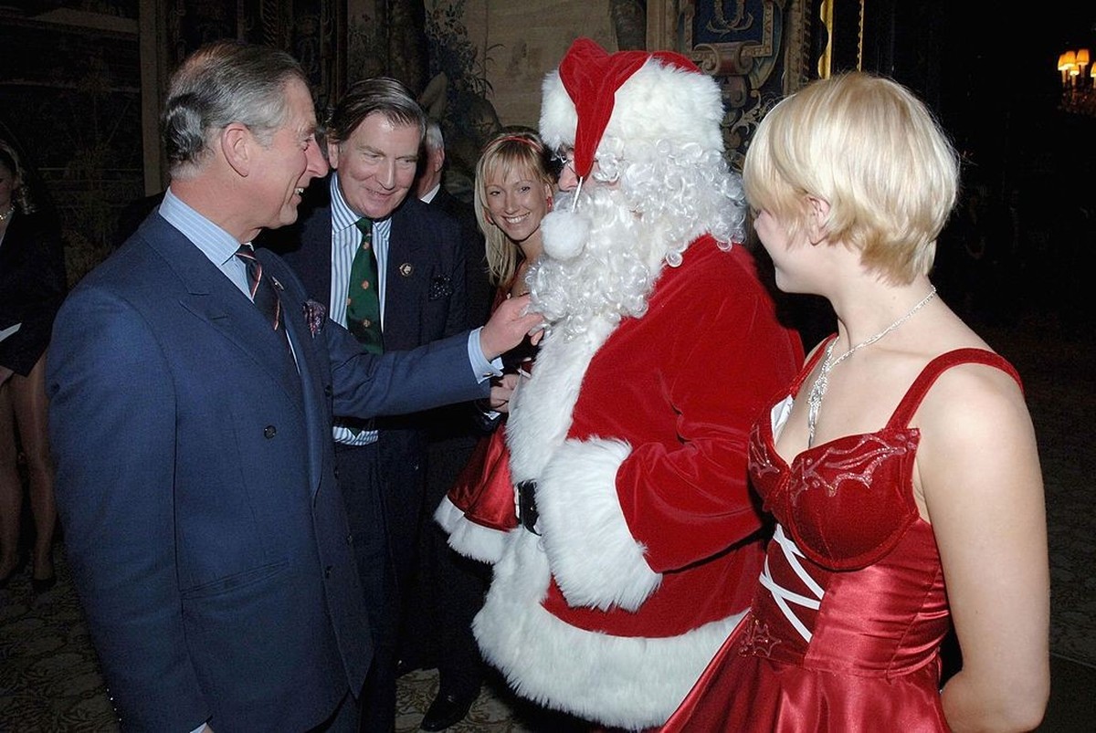 LONDON - DECEMBER 7: (NO PUBLICATION IN UK MEDIA FOR 28 DAYS) Prince Charles, Prince of Wales pulls the beard of Father Christmas as he visits the 'Not Forgotten Association' at St. James  ...