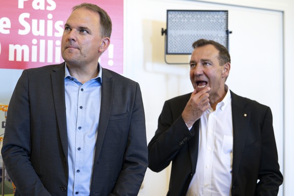 National Council member Thomas Matter, SVP-ZH, right, and National Council member and party president Marcel Dettling, SVP-SZ, left, react at the polling station for the SVPs popular initiative Yes  ...