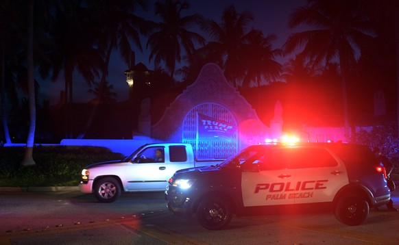 epa10112020 Authorities stand outside Mar-a-Lago, the residence of former president Donald Trump, amid reports of the FBI executing a search warrant as a part of a document investigation, in Palm Beac ...