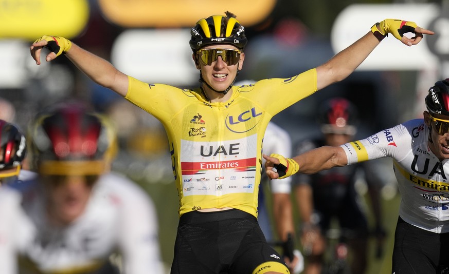 Tour de France winner Slovenia&#039;s Tadej Pogacar, wearing the overall leader&#039;s yellow jersey, celebrates as he crosses the finish line of the twenty-first and last stage of the Tour de France  ...