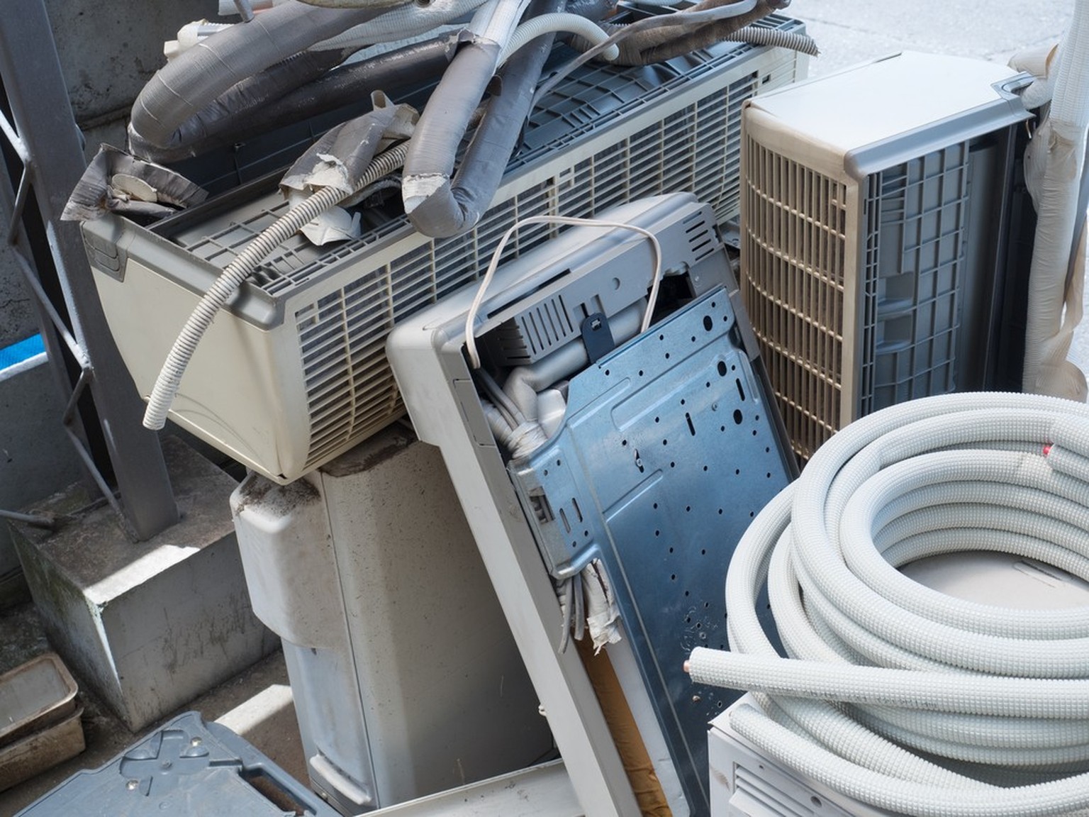 Discard or collect and recycle old air conditioners or HVACs.  Piled up old AC units.  Chlorofluorocarbons (CFCs)