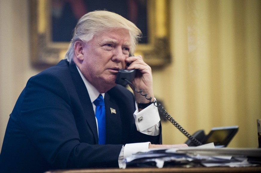 epa05758039 US President Donald J. Trump speaks on the phone with Prime Minister of Australia, Malcolm Turnbull, in the Oval Office in Washington, DC, USA, 28 January 2017. The call was one of five ca ...