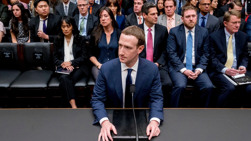 In this Aprill 11, 2018, photo, Facebook CEO Mark Zuckerberg arrives to testify before a House Energy and Commerce hearing on Capitol Hill in Washington, about the use of Facebook data to target Ameri ...