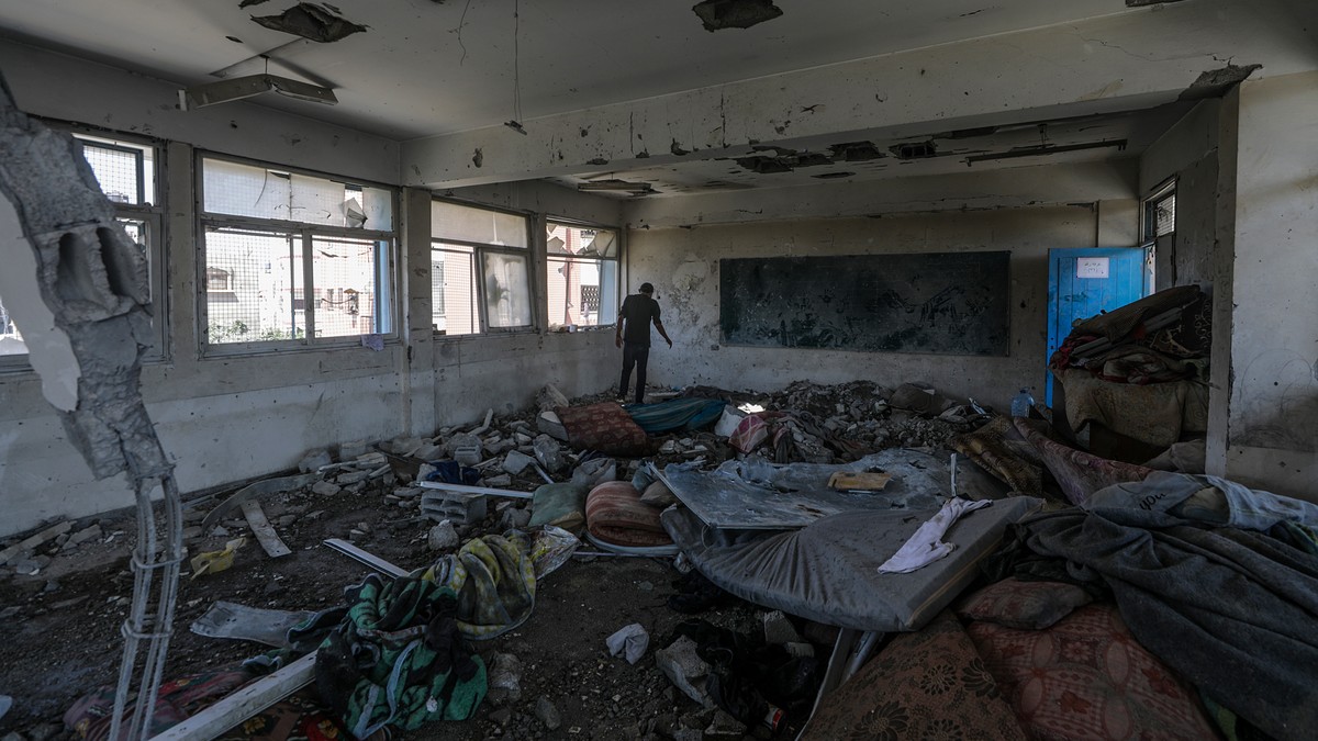 epa11392972 A Palestinians inspects the damages at a destroyed UNRWA school building following an Israeli airstrike in Al Nusairat refugee camp in the central Gaza Strip, 06 June 2024. According to th ...