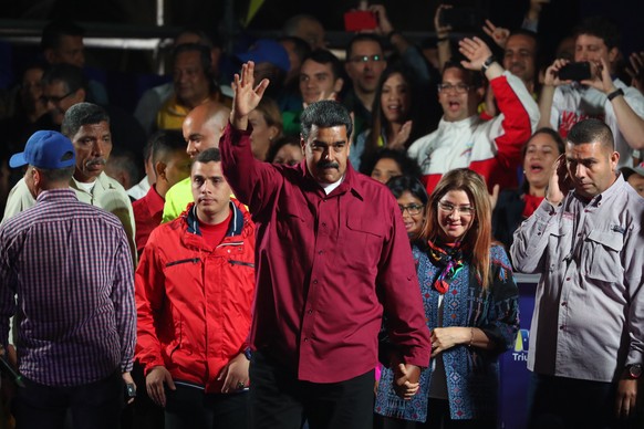 epaselect epa06753563 Venezuelan President Nicolas Maduro (C) jubilates his victory with First Lady Cilia Flores (C-R) after the publication of the electoral results in Caracas, Venezuela, 20 May 2018 ...