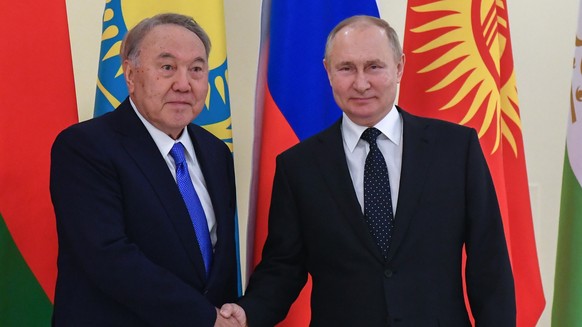 epa09658809 Russian President Vladimir Putin (R) greets former Kazakh President Nursultan Nazarbayev before an informal annual summit of the Commonwealth of Independent States (CIS) heads of state at  ...