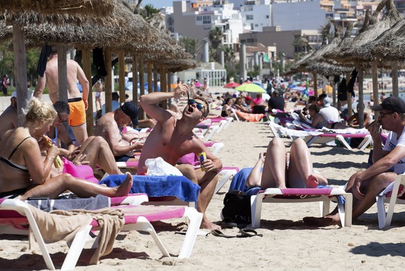 Tourists sunbathe on the beach at the Spanish Balearic Island of Mallorca, Spain, Monday, June 7, 2021. Spain is jumpstarting its summer tourism season by welcoming vaccinated visitors from most count ...