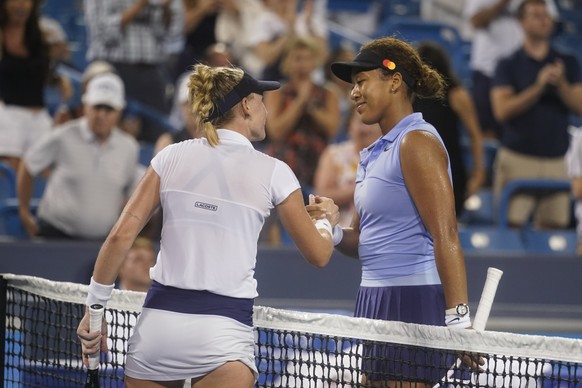 Jil Teichmann, left, of Switzerland, is congratulated by Naomi Osaka, of Japan, on Teichmann&#039;s win during the Western &amp; Southern Open tennis tournament Thursday, Aug. 19, 2021, in Mason, Ohio ...