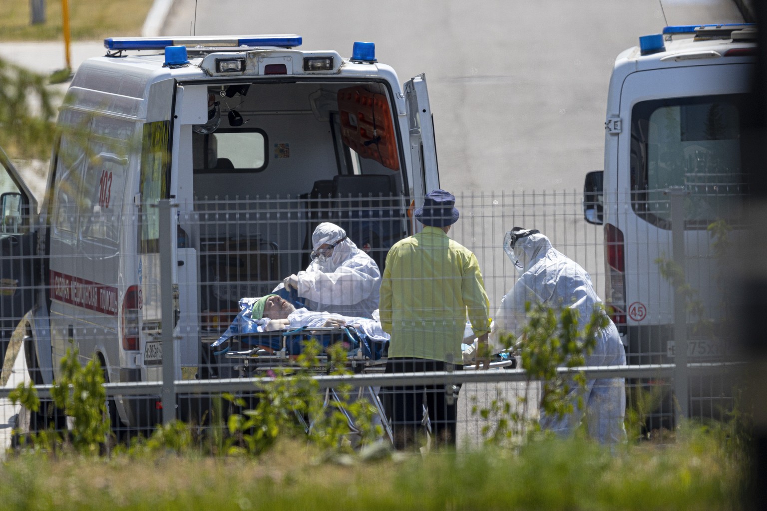 Medical workers carry a patient suspected of having coronavirus on a stretcher at a hospital in Kommunarka, outside Moscow, Russia, Saturday, June 26, 2021. Russia on Saturday reported its highest dai ...