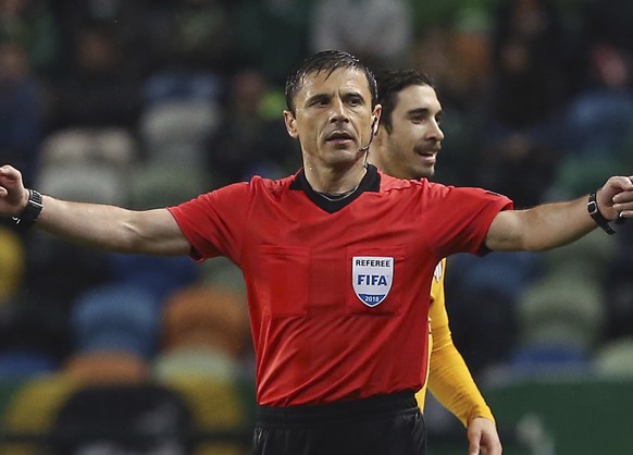 FILE - In this Thursday, April 12, 2018 file photo, referee Milorad Mazic gestures during the Europa League quarterfinal second leg soccer match between Sporting CP and Atletico Madrid at the Alvalade ...