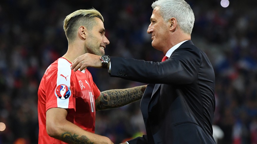 Switzerland coach Vladimir Petkovic, right, celebrates with Switzerland's Valon Behrami at the end of the Euro 2016 Group A soccer match between Switzerland and France at the Pierre Mauroy stadium in  ...