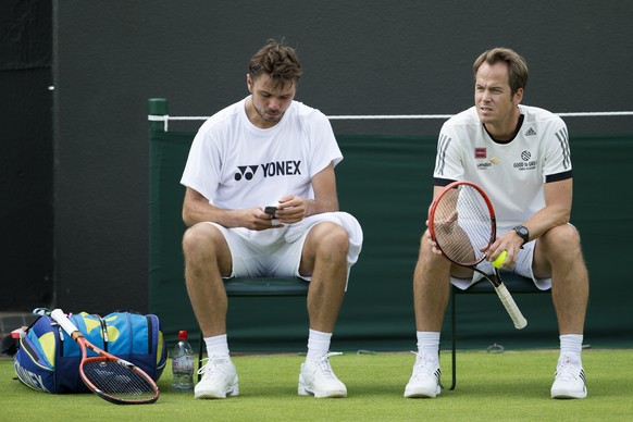 Stanislas Wawrinka of Switzerland, left, and his coach Magnus Norman of Sweden, during a training session at the All England Lawn Tennis Championships in Wimbledon, London, Saturday, June 27, 2015. (K ...