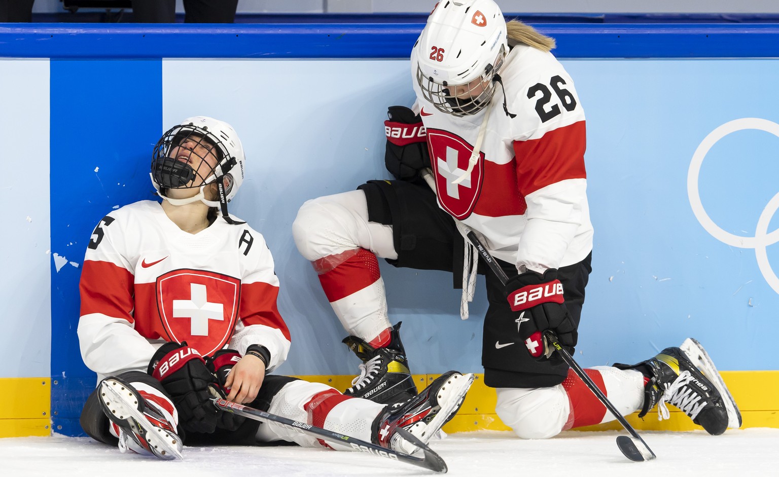 Switzerland&#039;s forward Alina Mueller, left, and Switzerland&#039;s forward Dominique Rueegg, right, look disappointed after losing the women&#039;s ice hockey Bronze Medal game between Finland and ...