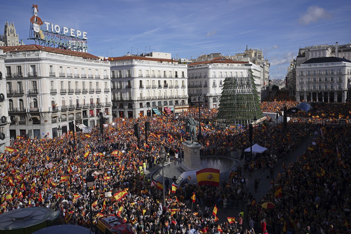 Crowds with Spanish flags pack the central Puerta del Sol during a protest called by Spain's Conservative Popular Party in Madrid, Spain, Sunday Nov.12, 2023. The Popular Party are protesting Spa ...