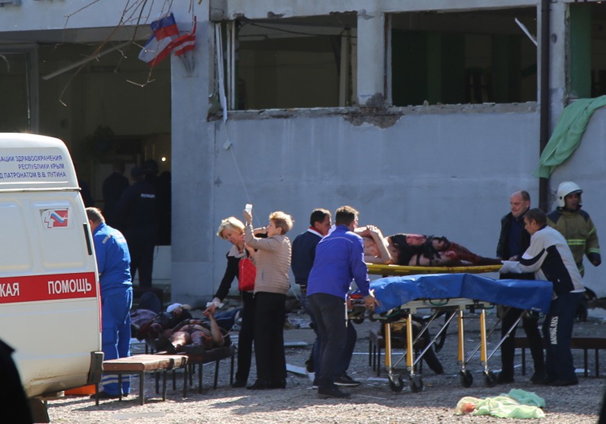 epa07099863 Rescuers work at a vocational school in Kerch in Crimea, 17 October 2018. About 18 people were killed and 40 injured in an suspected explosion and shooting in the school. According to the  ...