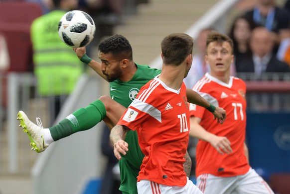 epa06807236 Fedor Smolov (C) of Russia in action against Mohammed Alburayk (L) of Saudi Arabia during the FIFA World Cup 2018 group A preliminary round soccer match between Russia and Saudi Arabia in  ...