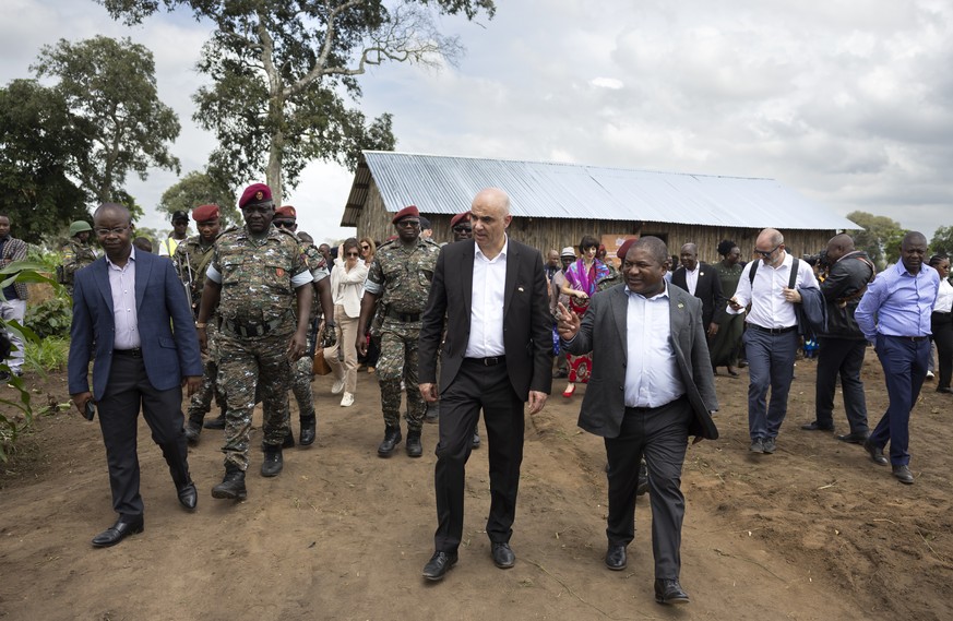 Mozambican President Filipe Jacinto Nyusi, front right, and Swiss Federal President Alain Berset, front left, visit the IDP camp (internally displaced people) in Mueda, Mozambique, Thursday, February  ...