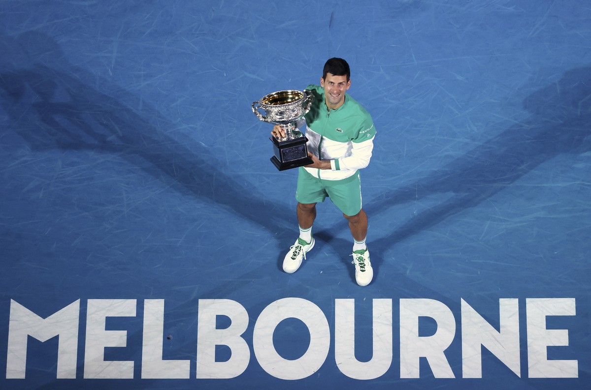 FILE- In this Feb. 21, 2021, file photo, Serbia's Novak Djokovic holds the Norman Brookes Challenge Cup after defeating Russia's Daniil Medvedev in the men's singles final at the Austra ...