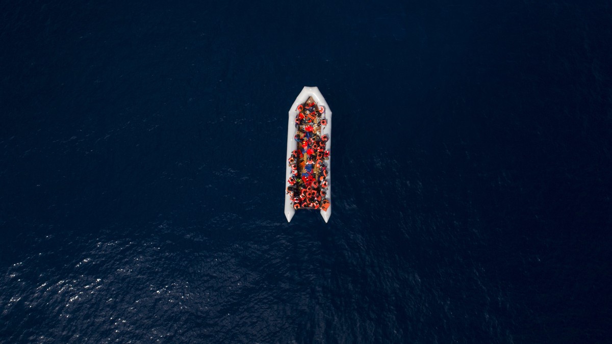 Refugees and migrants wait to be rescued by members of the Spanish NGO Proactiva Open Arms, after leaving Libya trying to reach European soil aboard an overcrowded rubber boat, north of Libyan coast,  ...